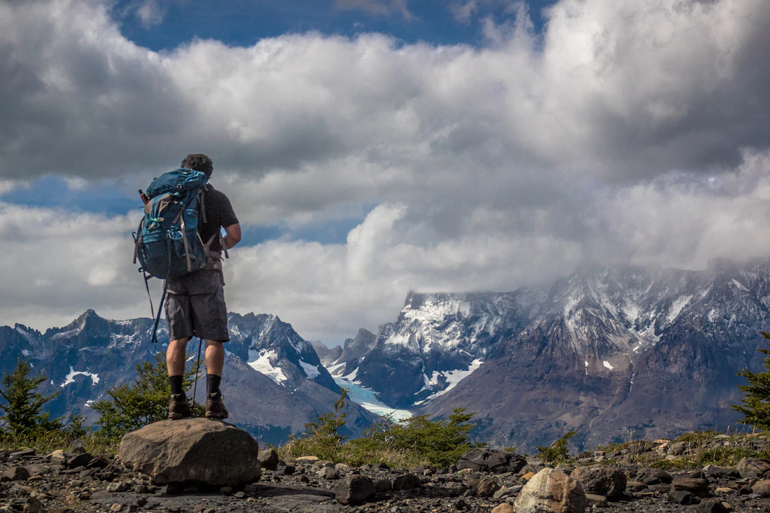 Hiker looking towards the mountains in Torres del Paine